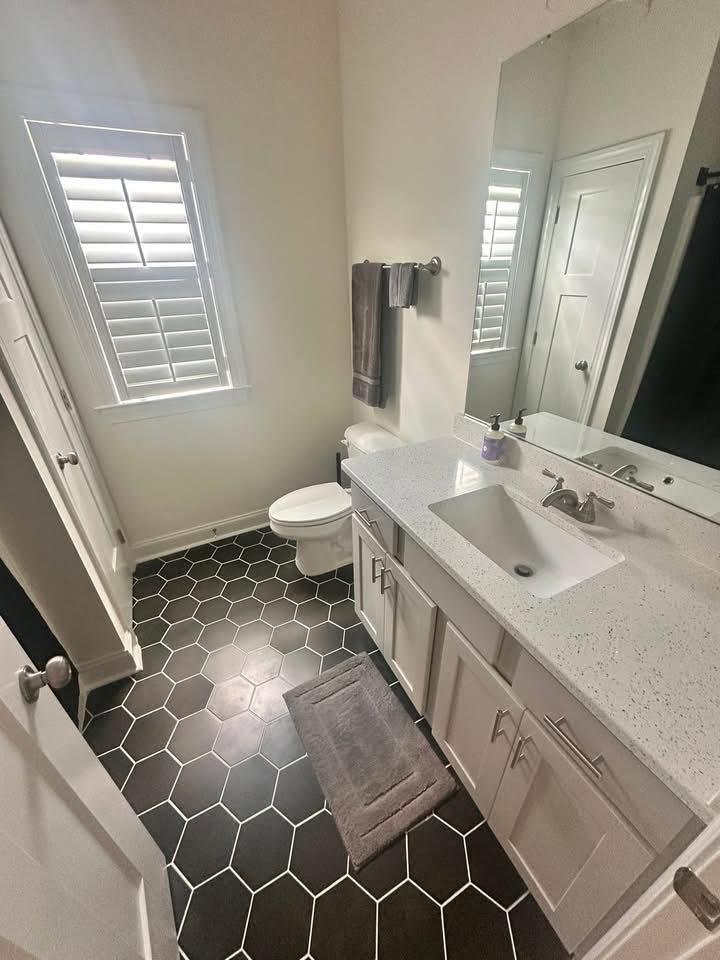 Freshly cleaned bathroom with hexagon tile floor