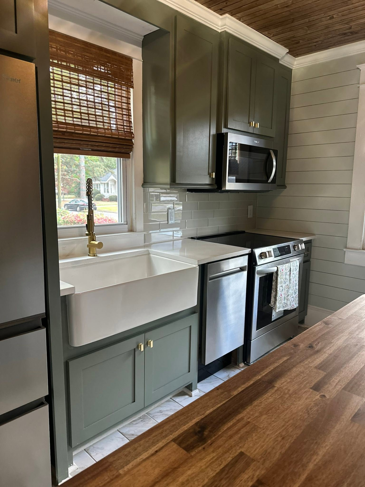 Sage green kitchen with farmhouse sink